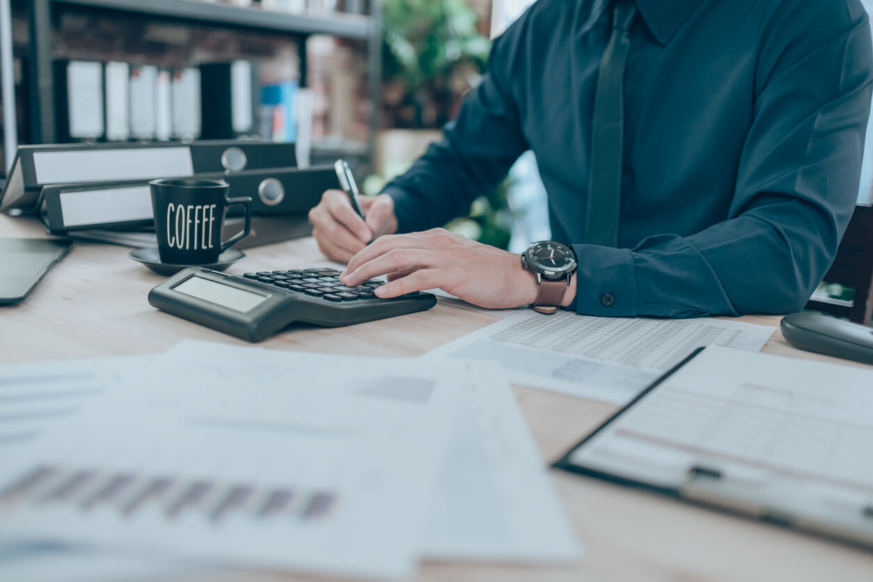 Un homme concentré sur la comptabilité, illustrant la gestion rigoureuse nécessaire pour profiter des avantages fiscaux de la SCI familiale. Une démarche clé pour optimiser les revenus et alléger la fiscalité sur le patrimoine immobilier.