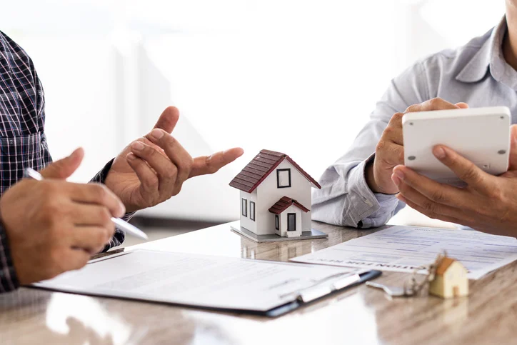 An office worker negotiating his fees with the owner of an apartment under rental management